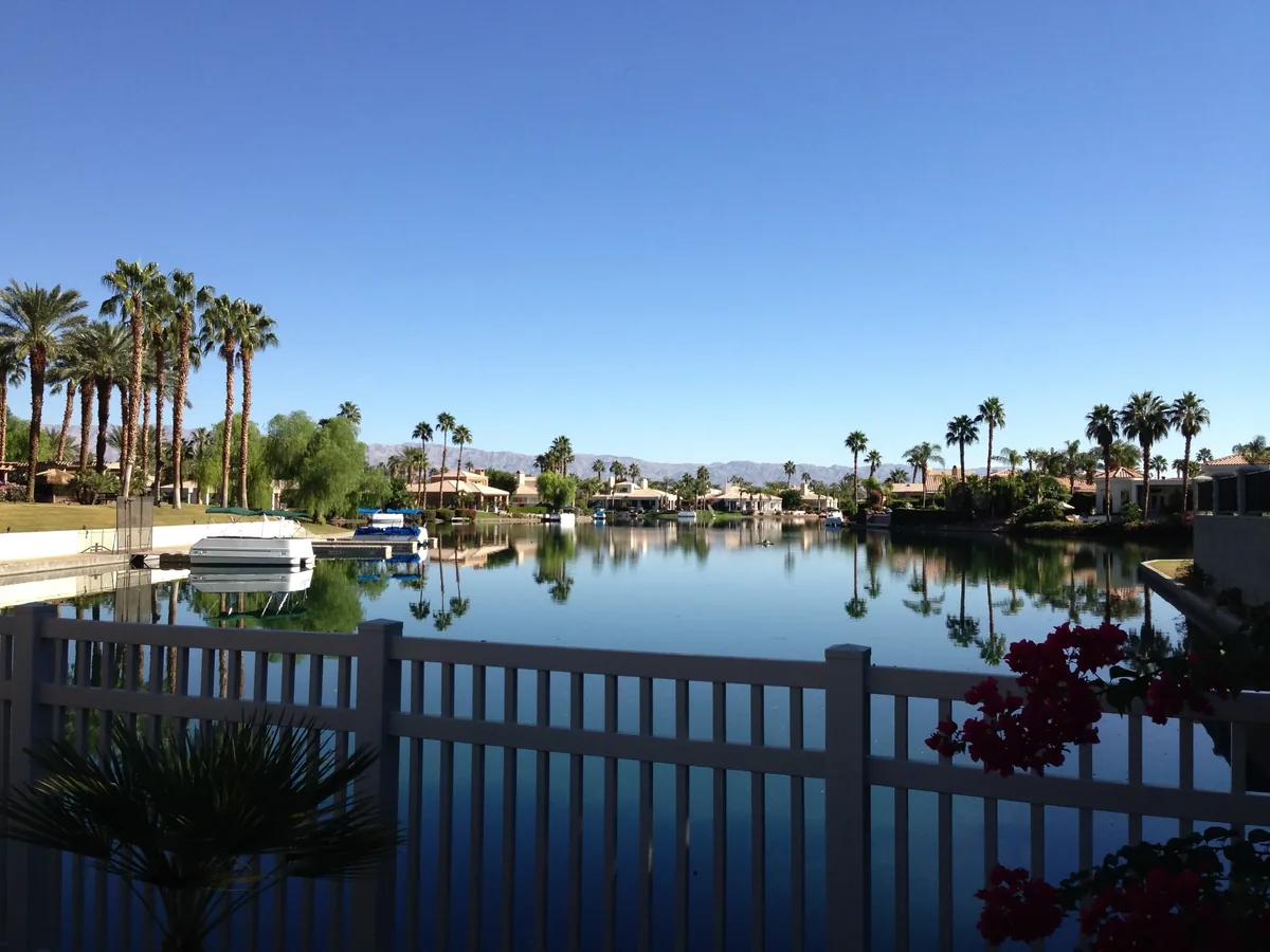 Waterfront homes and palms in La Quinta